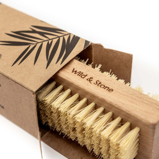 Wooden brush with natural bristles in a 'Wild & Stone' branded box on a white background