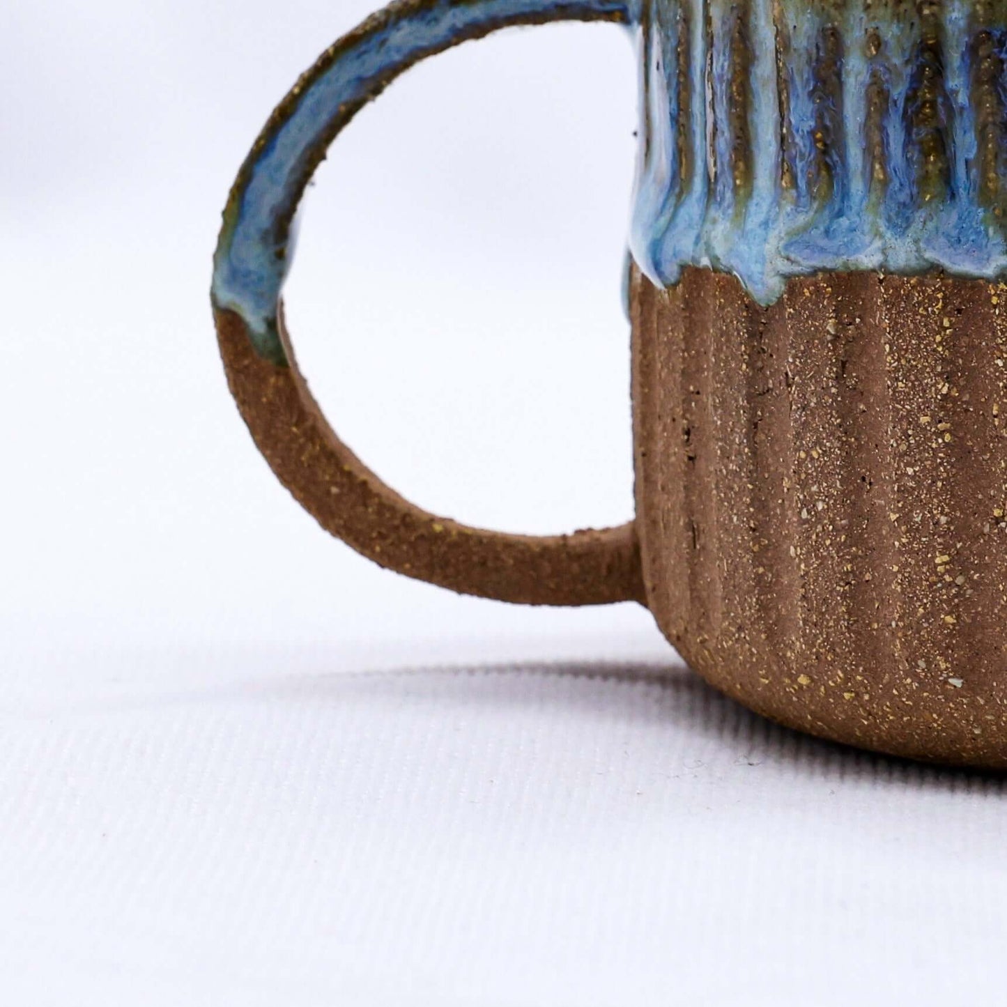 Bluvio Arte Handmade Ceramic Terra Stoneware Mug showcasing unique texture and design, eco-friendly and perfect for stylish use.