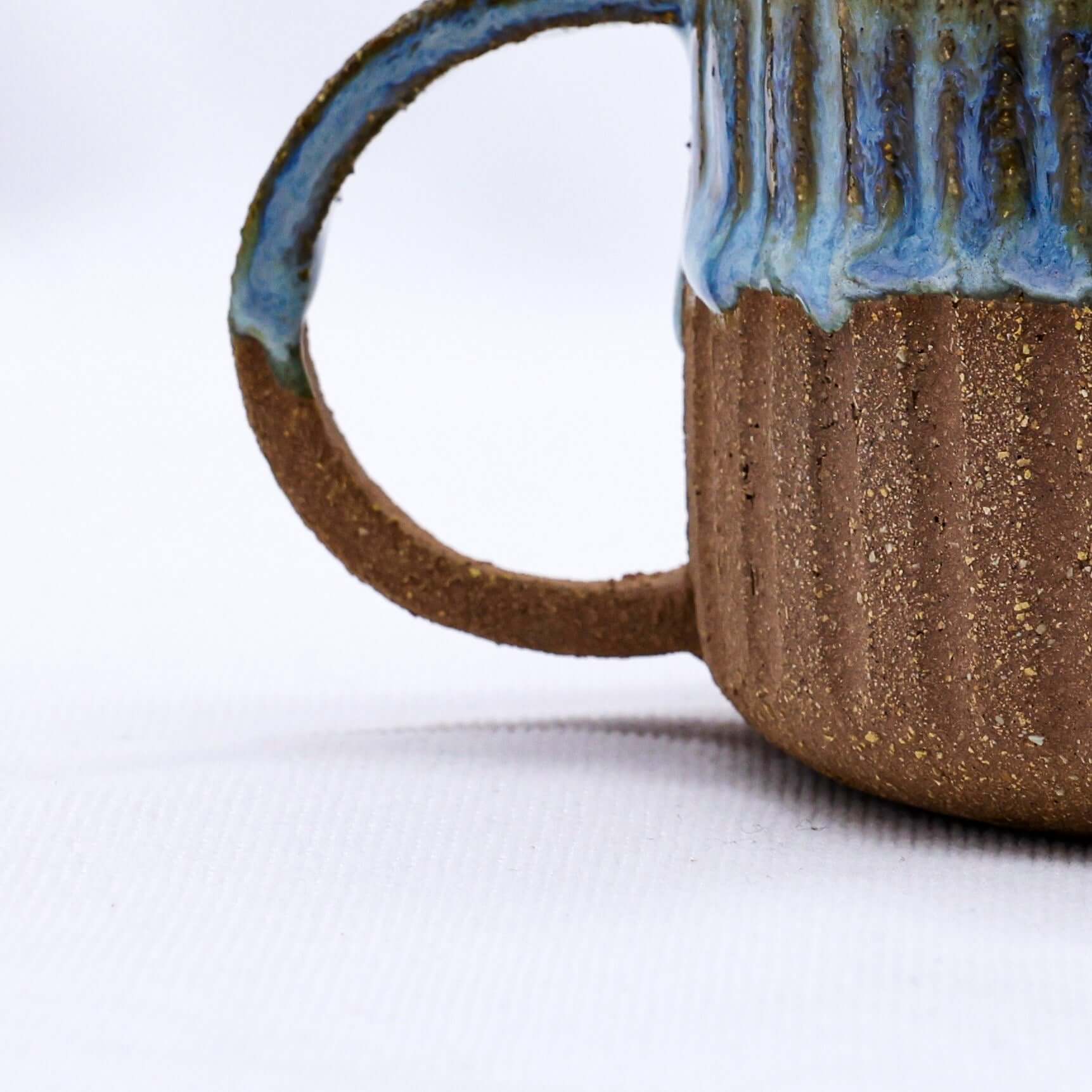 Bluvio Arte Handmade Ceramic Terra Stoneware Mug showcasing unique texture and design, eco-friendly and perfect for stylish use.