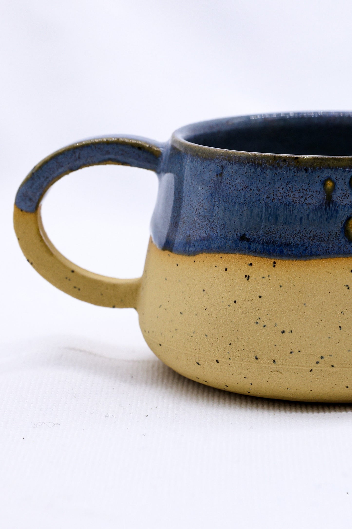 Bluvio Belluma Handmade Stoneware Ceramic Mug showcasing elegant blue and yellow design, eco-friendly, from UK, Brighton and Hove.