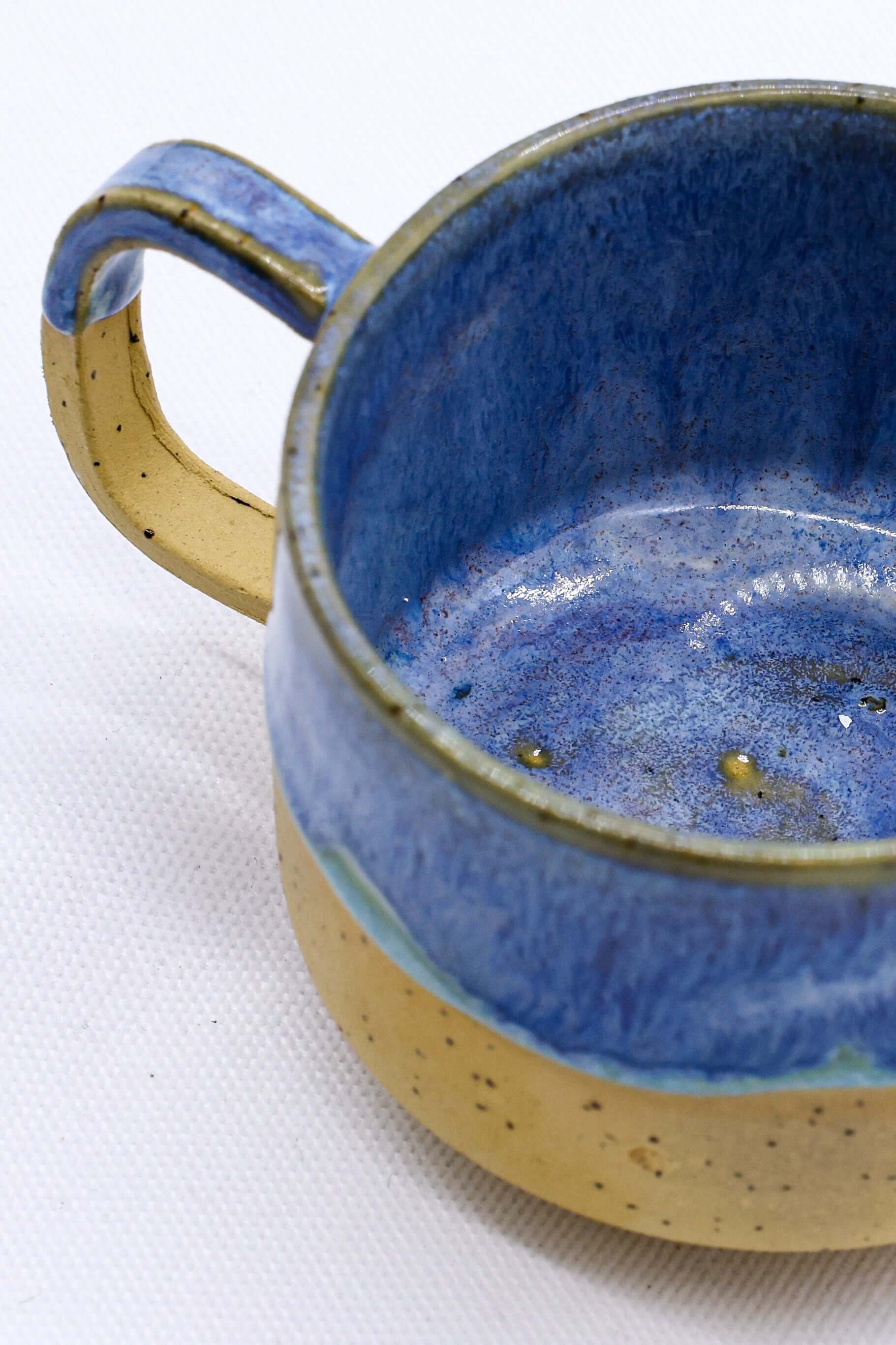 Bluvio Sienna Handmade Ceramic Mug showcasing blue interior and gold exterior, eco-friendly from UK, Brighton and Hove.