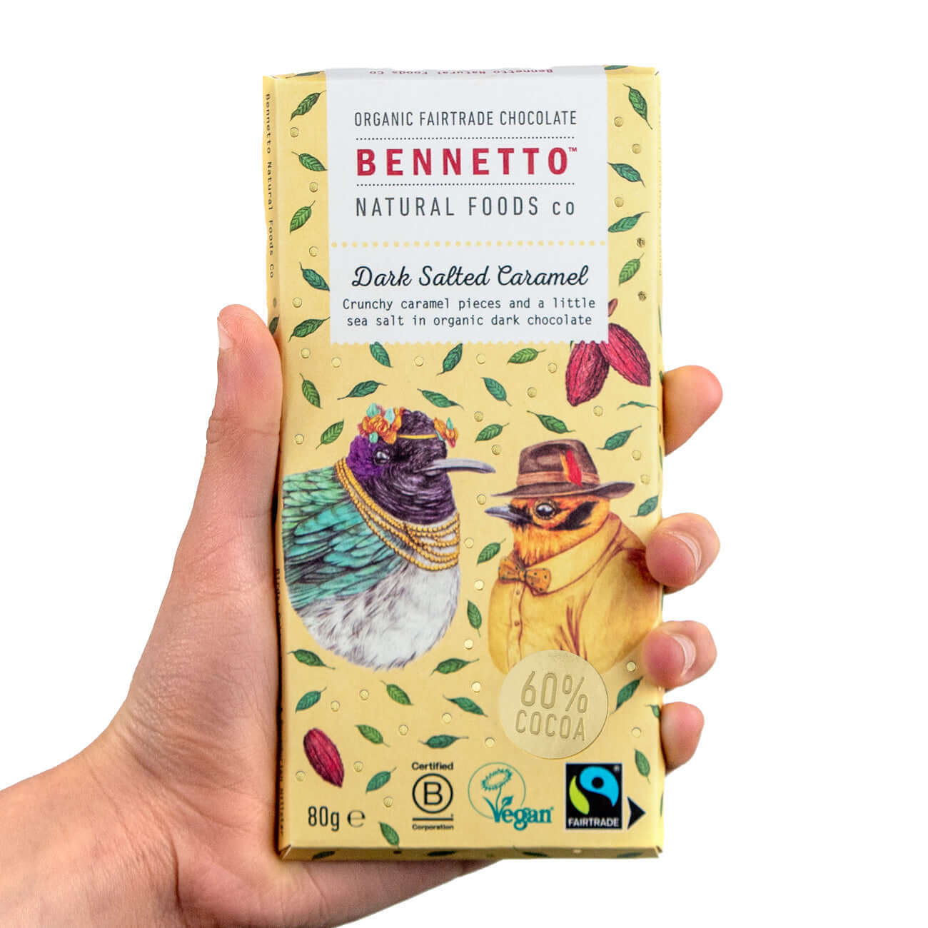 Hand holding a pack of Dark Salted Caramel chocolate by Bennetto, featuring eco-friendly ingredients from Fairtrade co-ops.