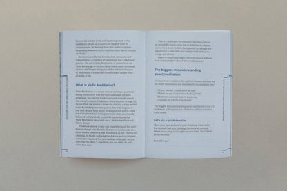 Open book pages discussing Vedic Meditation and understanding meditation concepts.