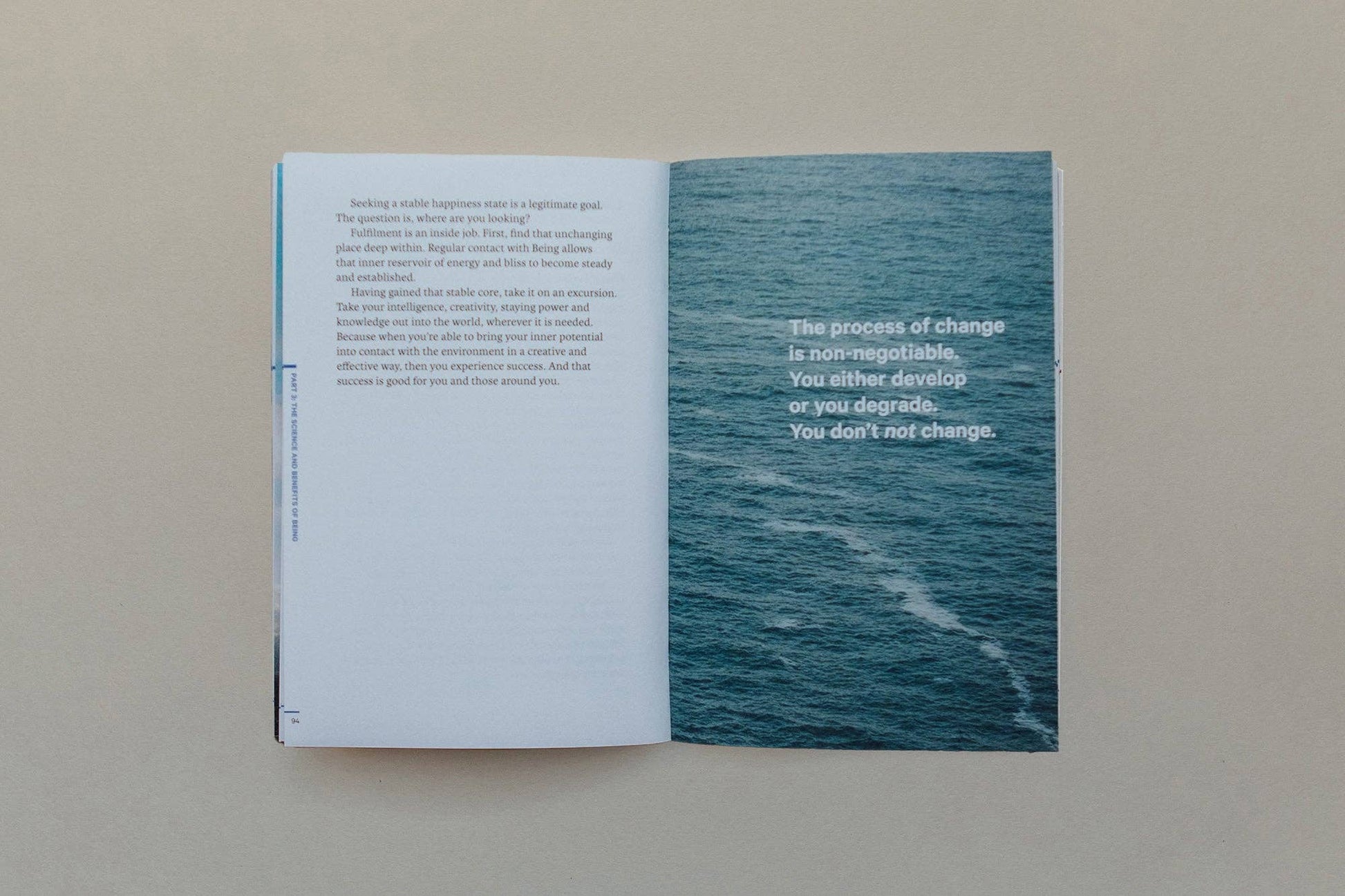 Interior pages of a book with text about change and an image of water, related to Vedic Meditation.