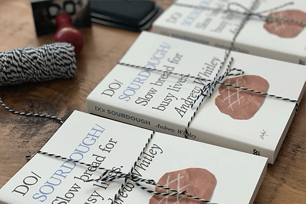Books tied with string on a wooden surface