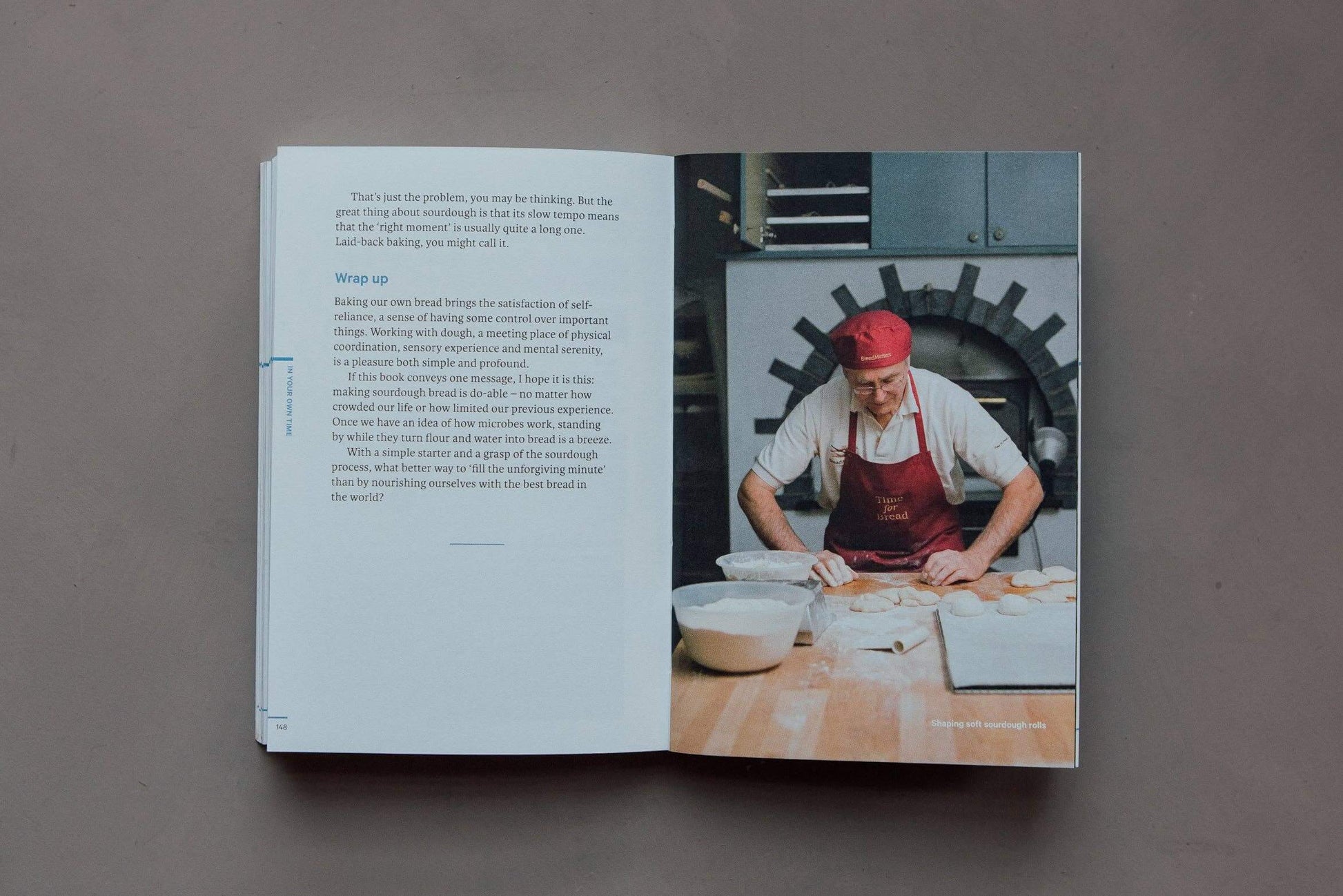 Open book showing a chef working in a kitchen with text on a gray background