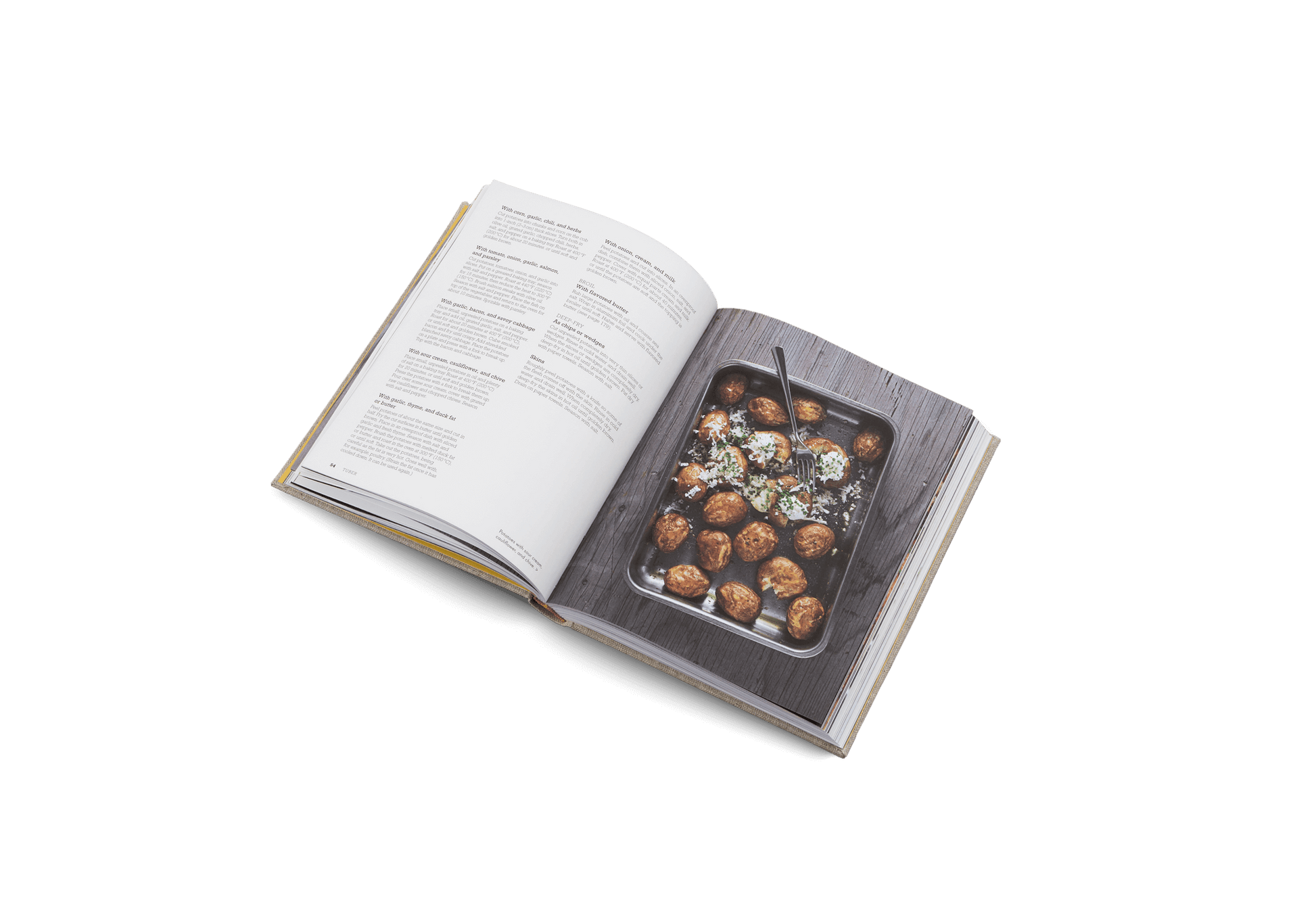 Open cookbook showing a page with a photograph of roasted vegetables on a white background