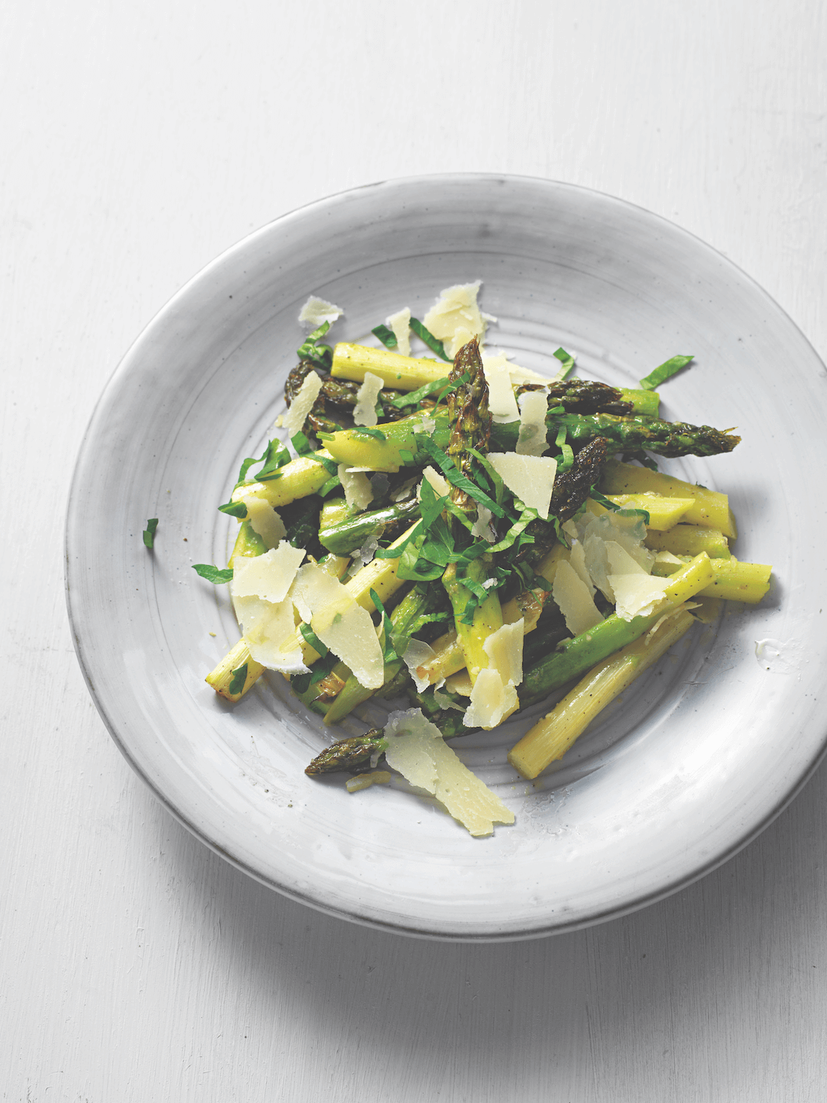 Plate of asparagus salad on a white background