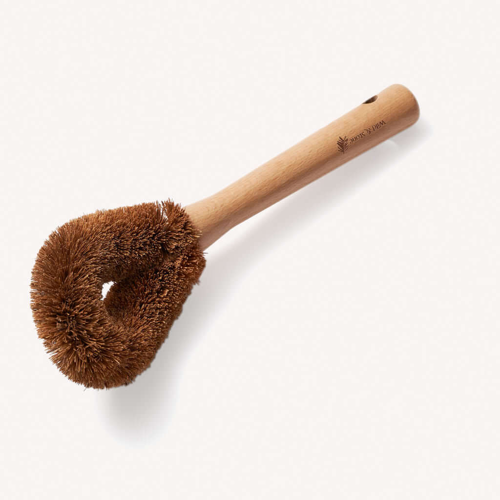 Wooden bottle brush with brown bristle head on a white background
