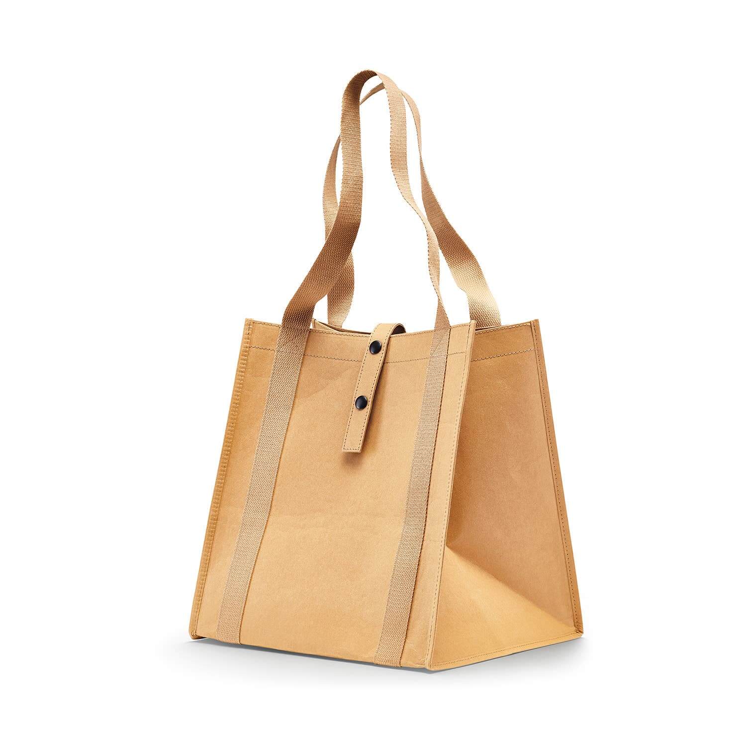 Beige tote bag with brown straps on a white background
