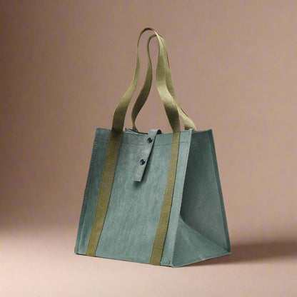 Green tote bag with brown straps on a white background