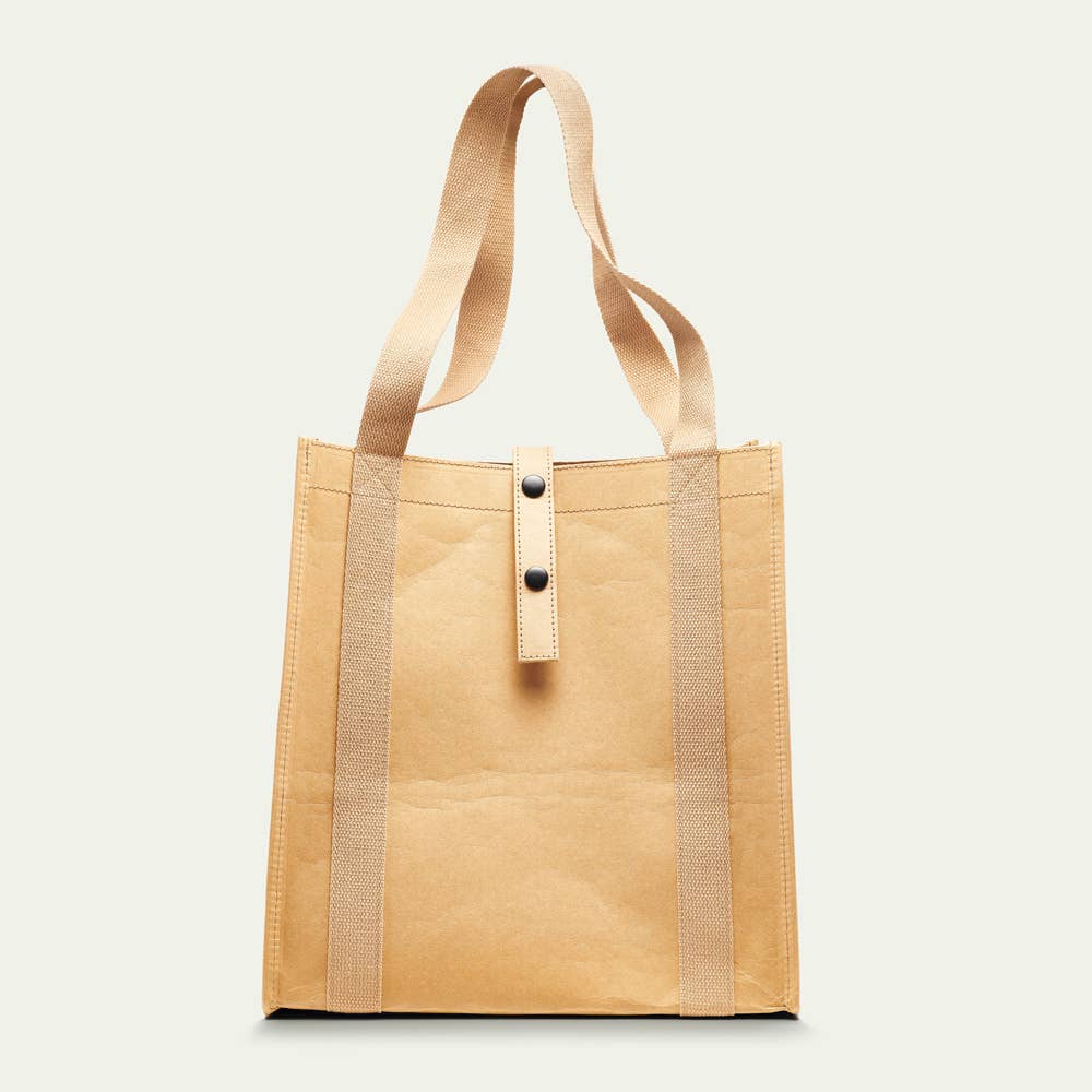Beige tote bag with a strap on a light beige background
