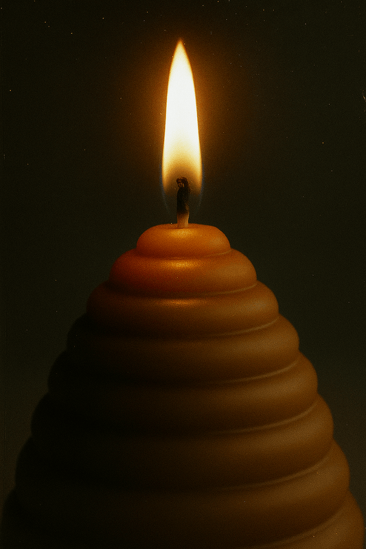 The Hive pillar candle made of pure beeswax with a glowing flame, size 12x12x12cm, burning time 36 hours.