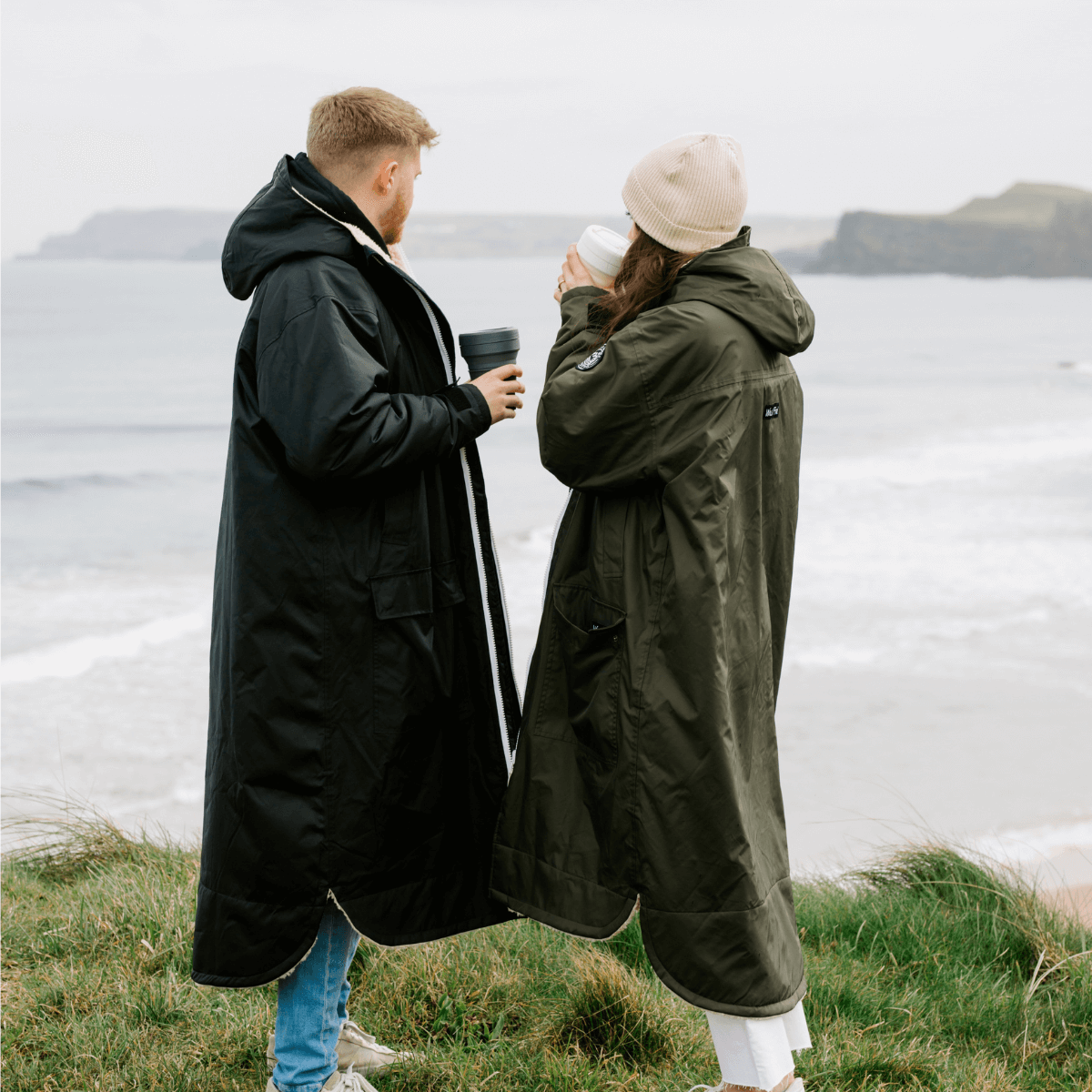 Raincoat & Changing Robe in One - The Classic Cobe Olive Green worn by two people at the beach.