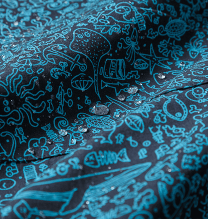 Close-up of water-repellent fabric featuring a marine-inspired print with droplets, perfect for eco-friendly rain ponchos.