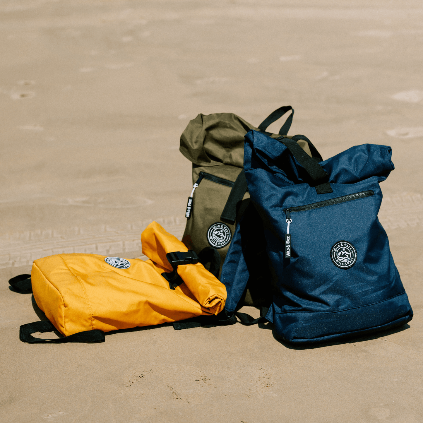 The Backpack in three colors: orange, green, and navy, perfect for adventures, available at Alewk.club.