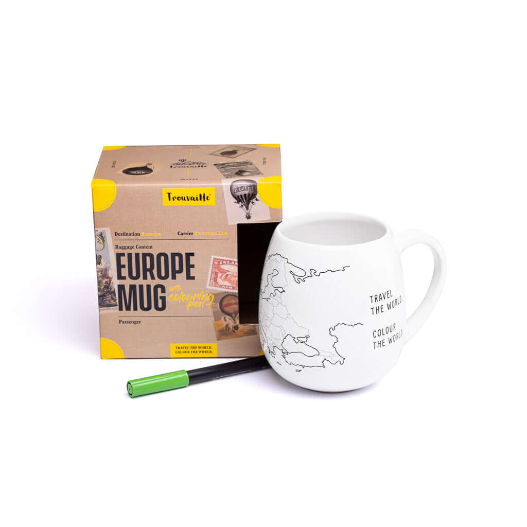 White mug with world map design, green pen, and Tassimo box on a white background