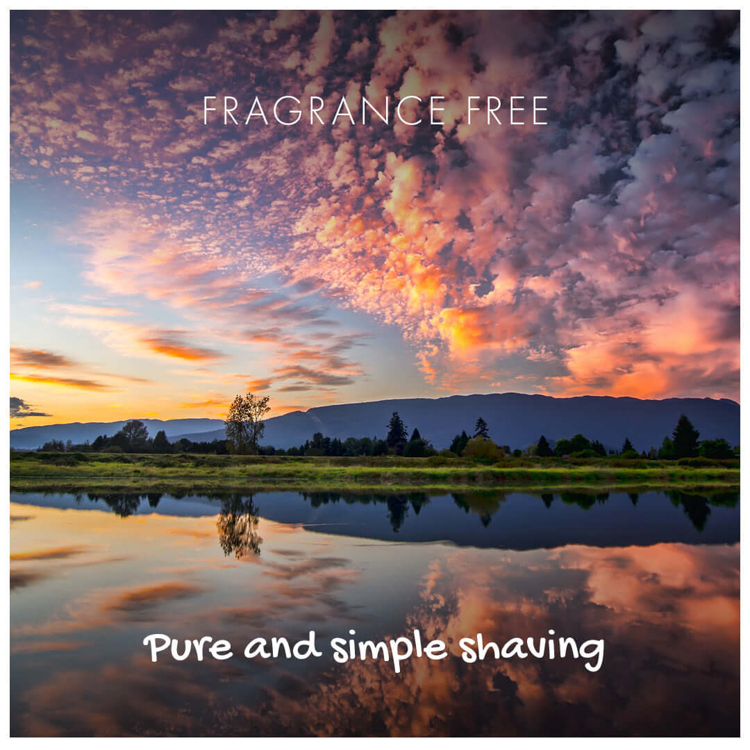 Scenic landscape with a lake and mountains at sunset, with 'Fragrance Free' and 'Pure and simple shaving' text.