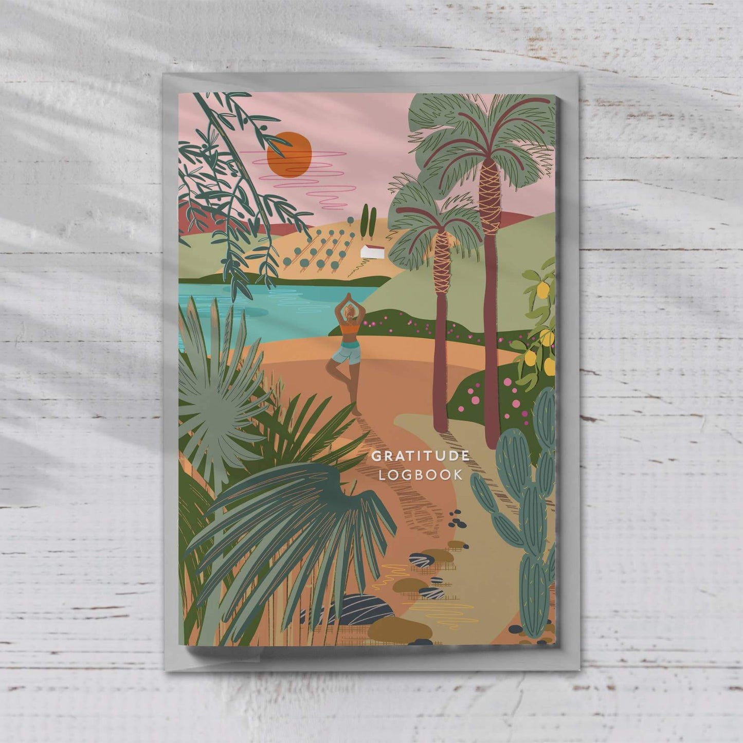 A beautifully illustrated A5 Gratitude Logbook by ONNEKE, featuring a yoga-themed cover design.