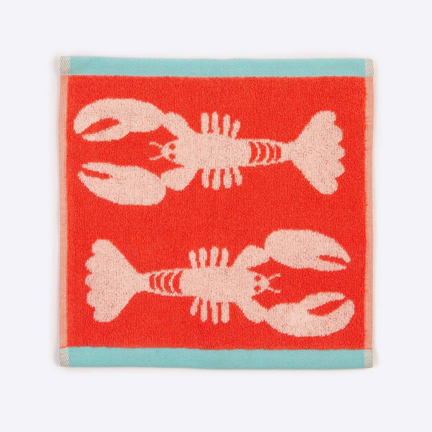 Red towel with pink lobster design on a white background