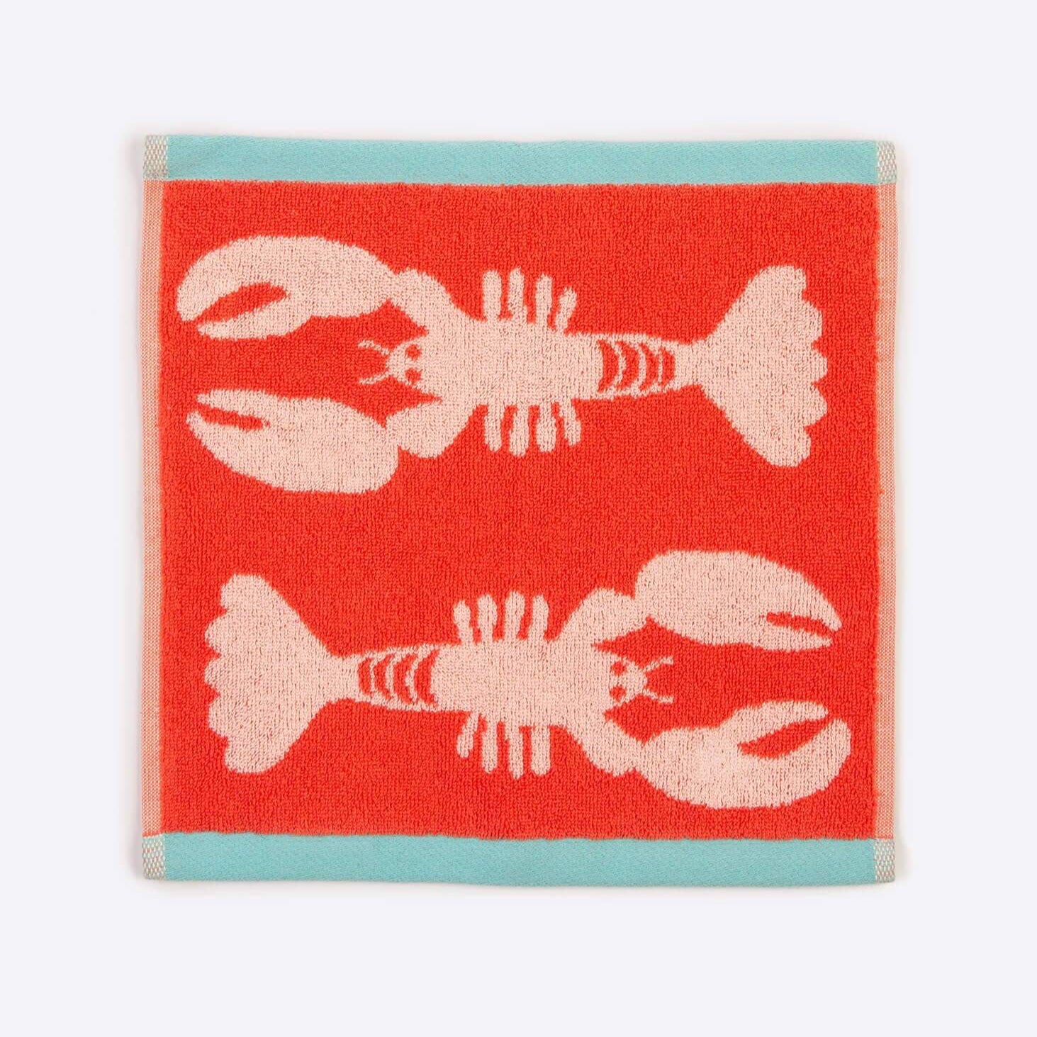 Red towel with pink lobster design on a white background