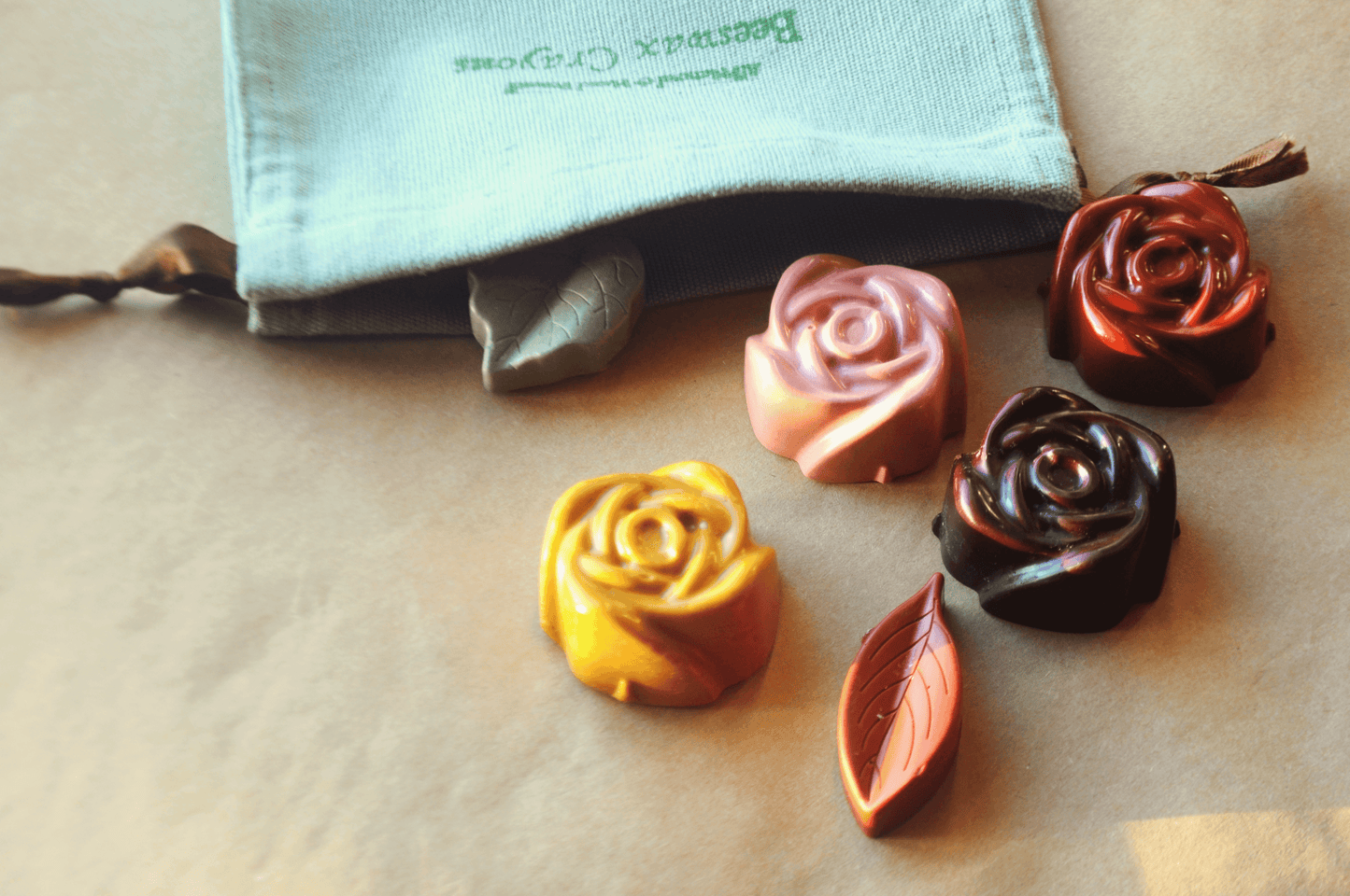Handmade Natural Jumbo Rose Beeswax Crayons – Set of 6 Crayons displayed with pouch and colorful crayon shapes.