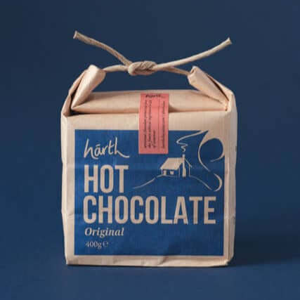 Box of hot chocolate with a blue label on a dark background