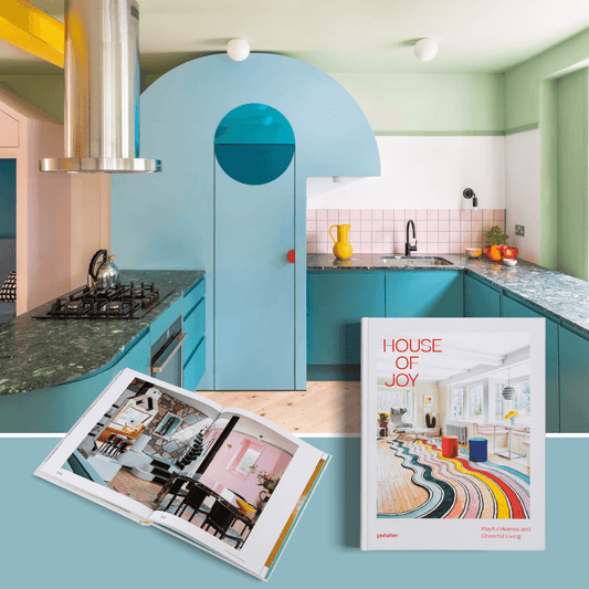 House of Joy playful interior design book on colorful kitchen countertop with vibrant interior features.
