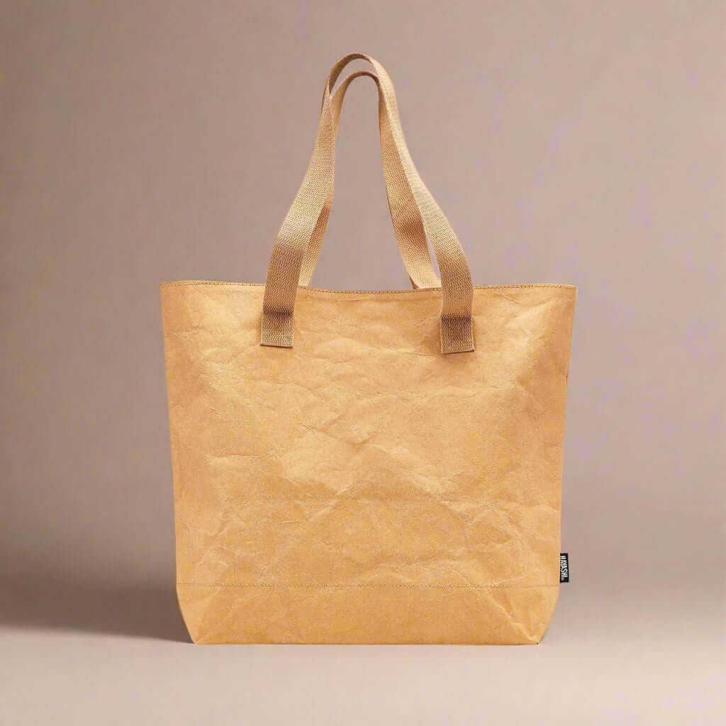 Beige tote bag with brown handles on a white background