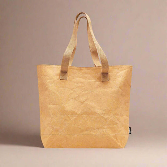Beige tote bag with brown handles on a white background