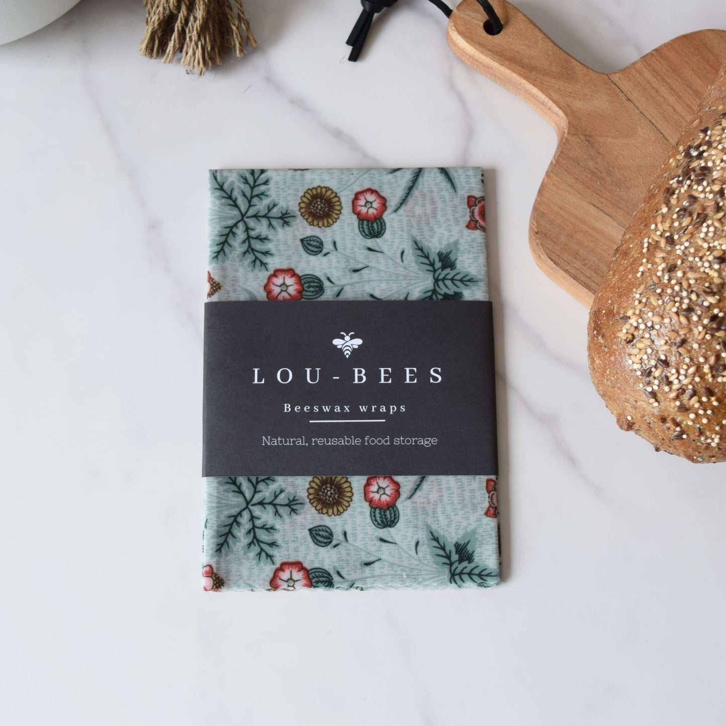 William Morris Large Beeswax wrap singles displayed on a marble surface next to fresh bread.