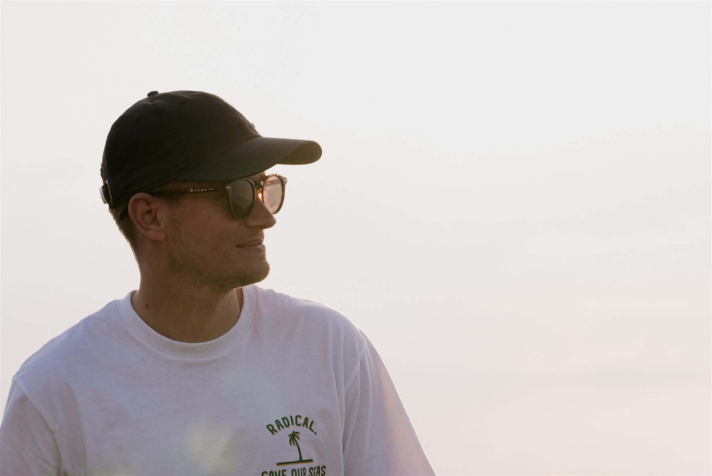 Luma Unisex Sunglasses - Fowey - Tortoise worn by a man at the beach, showcasing eco-friendly style and sun protection.