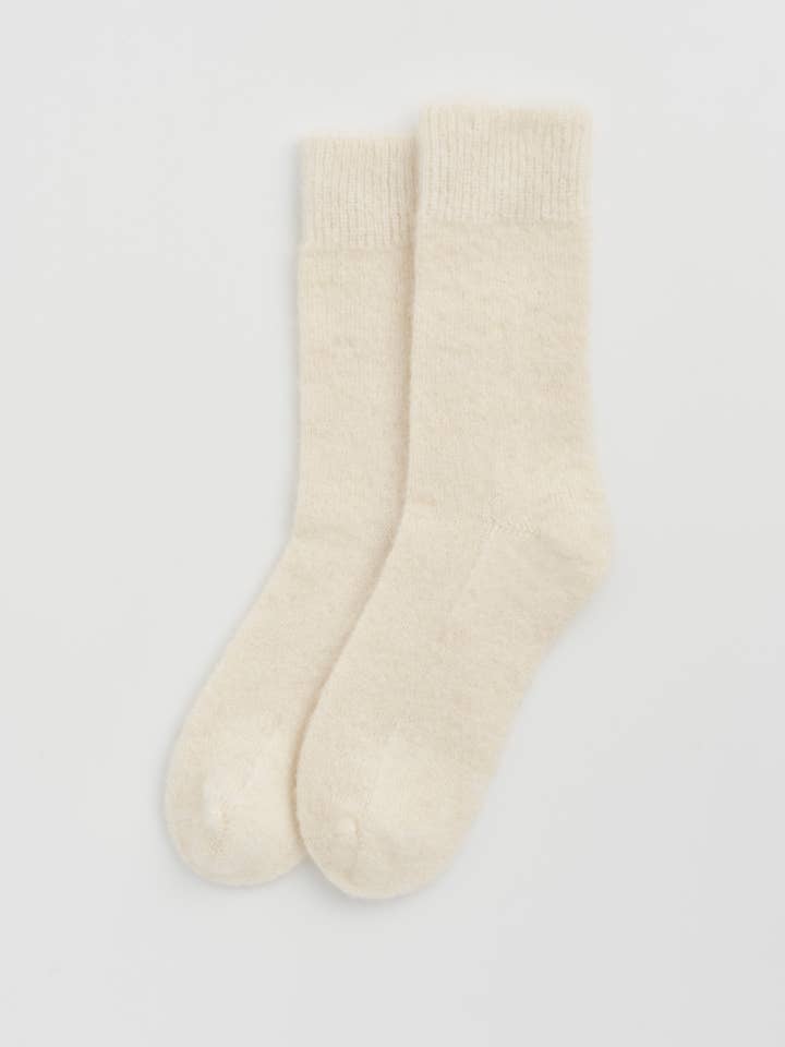 Ultra soft and warm Alpaca Bed Socks in cream color, perfect for a cozy night in.