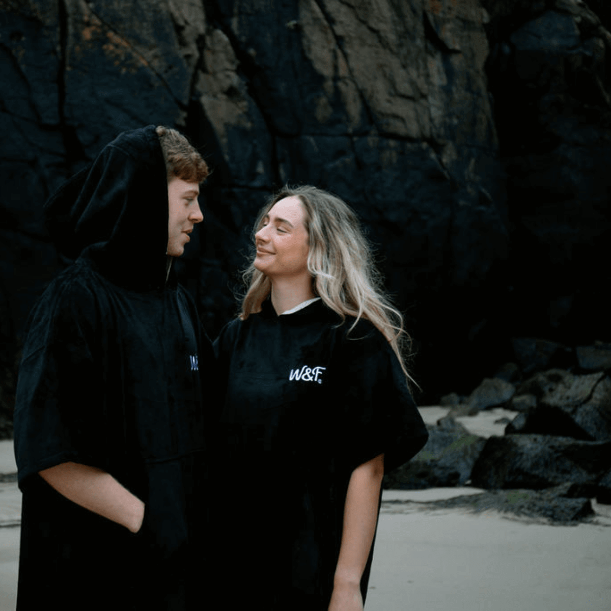 Couple wearing The Luxury Towel Robe by Wild & Free, enjoying a beach setting with a stylish look.