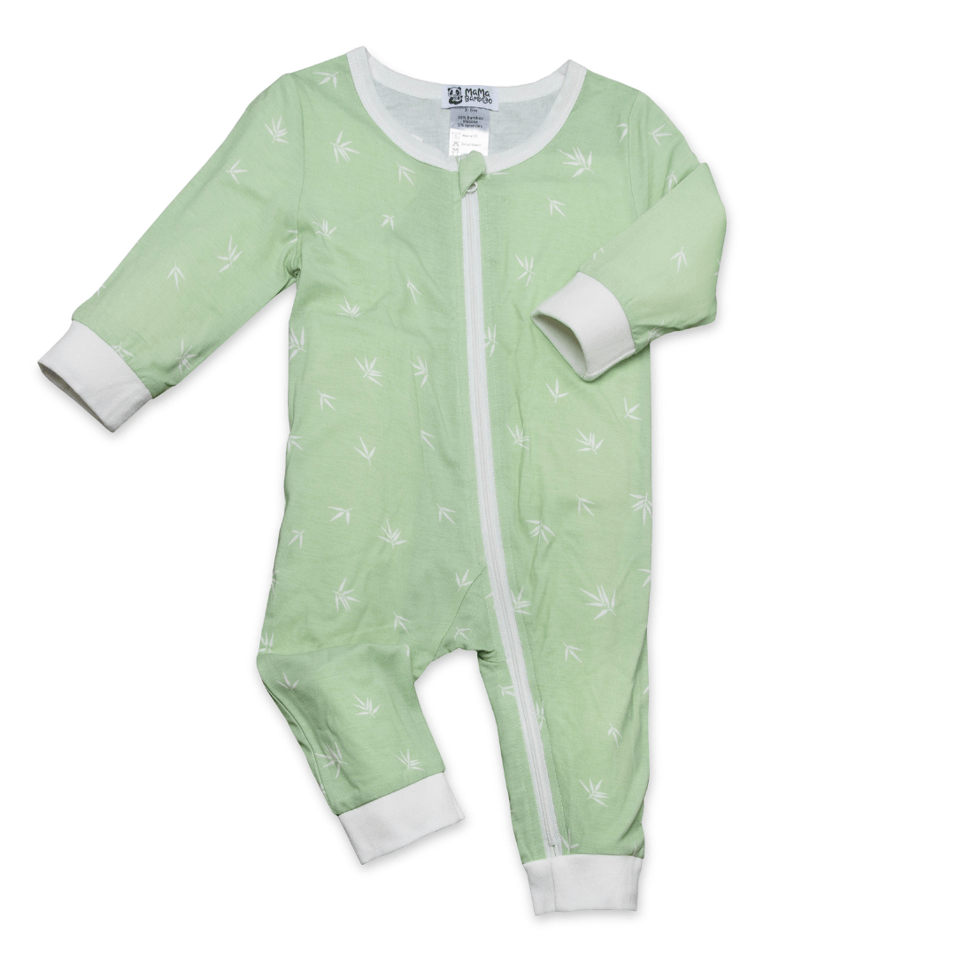 Green baby onesie with white patterns on a white background
