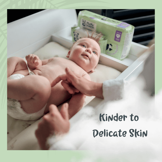 Baby lying on a changing table with a diaper and text 'Kinder to Delicate Skin'.