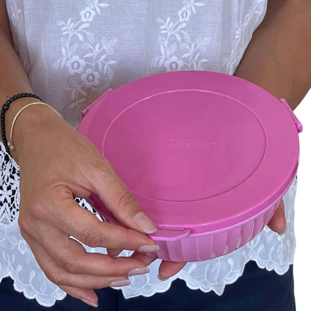 NEW! Yumbox Poke Bowl with 4 Compartment Divider - Various Colours, shown in pink being held by a person.