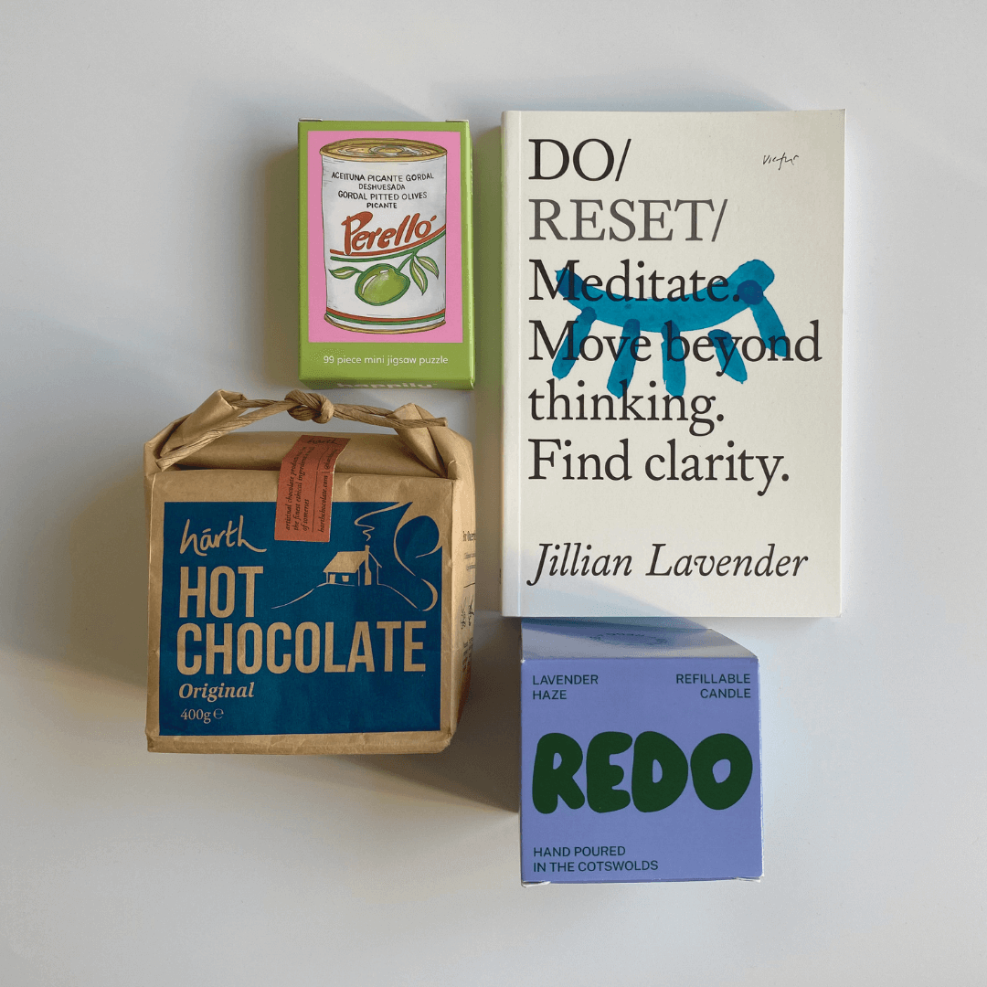 Collection of products including a book, hot chocolate box, and candle on a white background