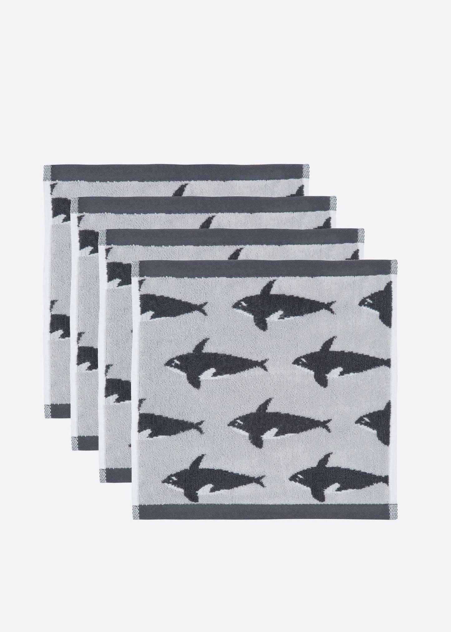Set of four gray napkins with black shark pattern on a white background