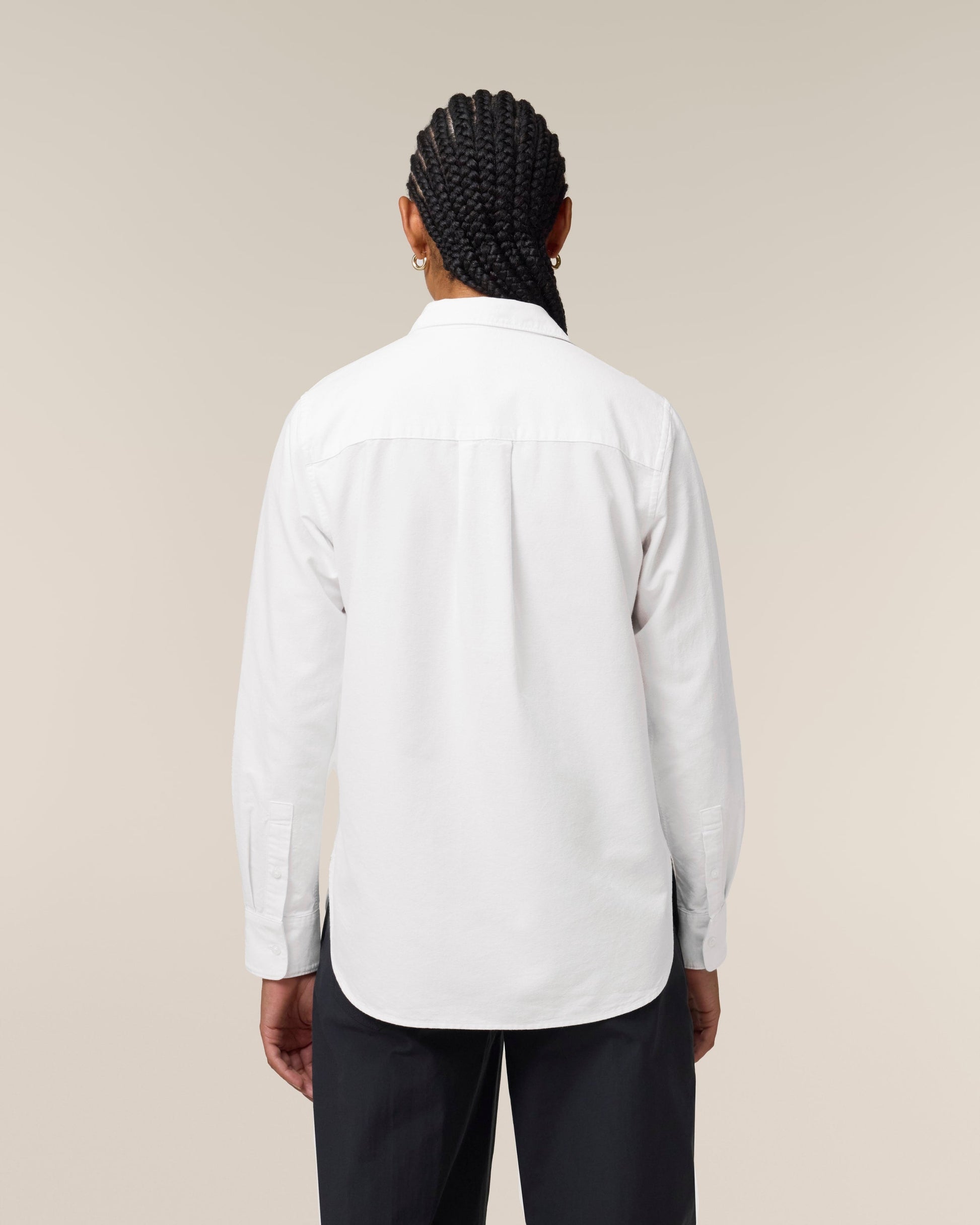 Back view of a woman wearing an Organic Cotton Oxford Long Sleeve Shirt: Womens, showcasing its elegant design and fit.