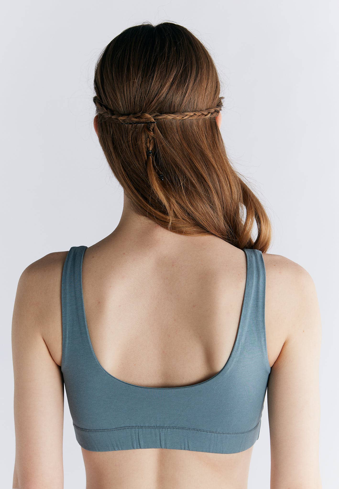Back view of woman wearing Organic Cotton Padded Bralette in blue, showcasing the wide straps and comfortable fit.