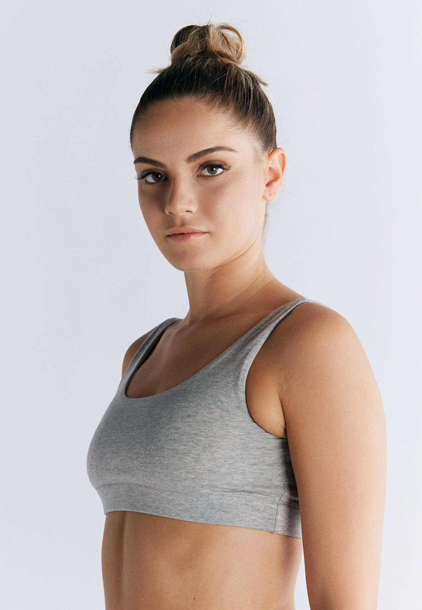 Model wearing an Organic Cotton Padded Bralette in grey, showcasing its comfortable and supportive design.