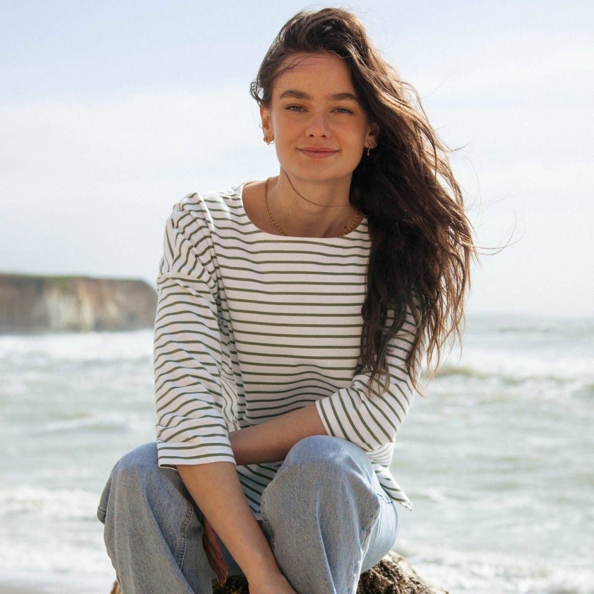 Organic Cotton Striped Boat Neck Top: Womens worn by a smiling woman at the beach, promoting eco-friendly fashion at alewk.club.
