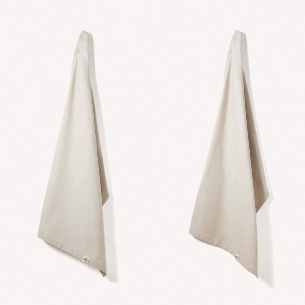 Organic Cotton Tea Towels - Herringbone Weave - Set of 2 hanging in a kitchen setting.
