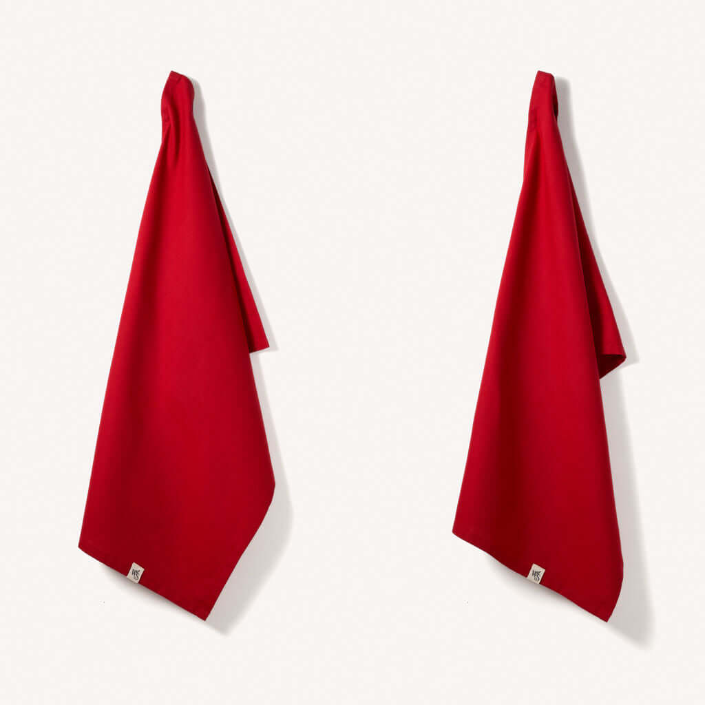 Organic Cotton Tea Towels - Herringbone Weave - Set of 2 hanging in vibrant red color.