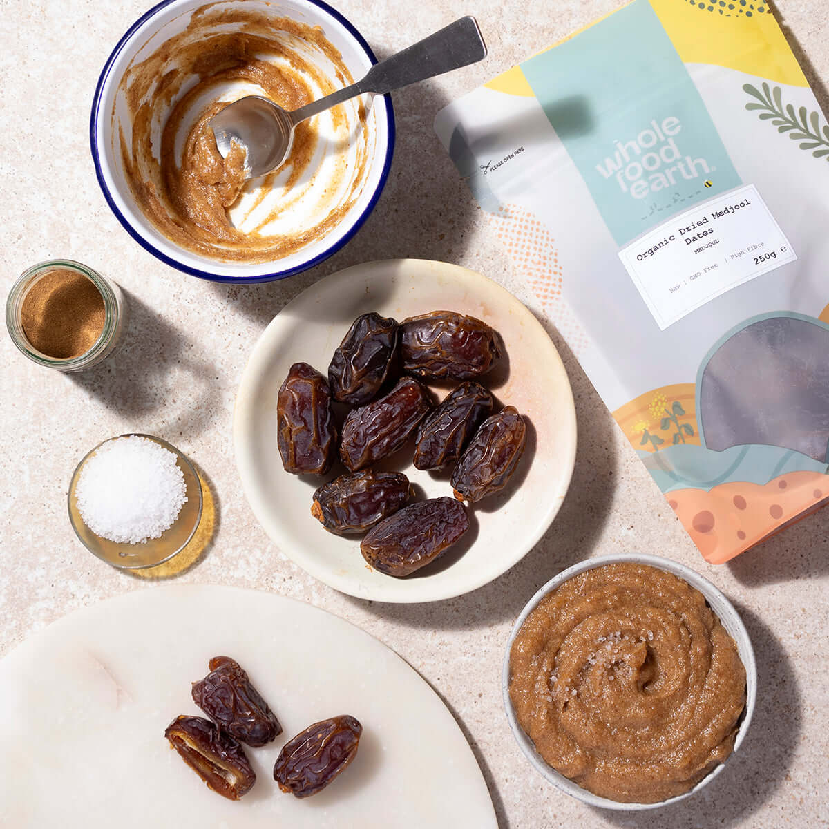 Date paste with dates and a package of whole food earth dates on a light surface