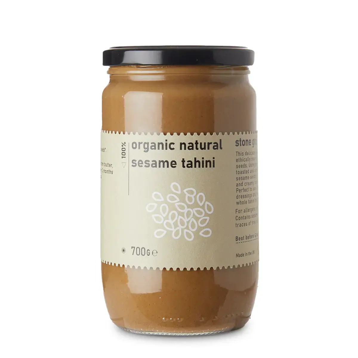 Jar of organic natural sesame tahini on a white background