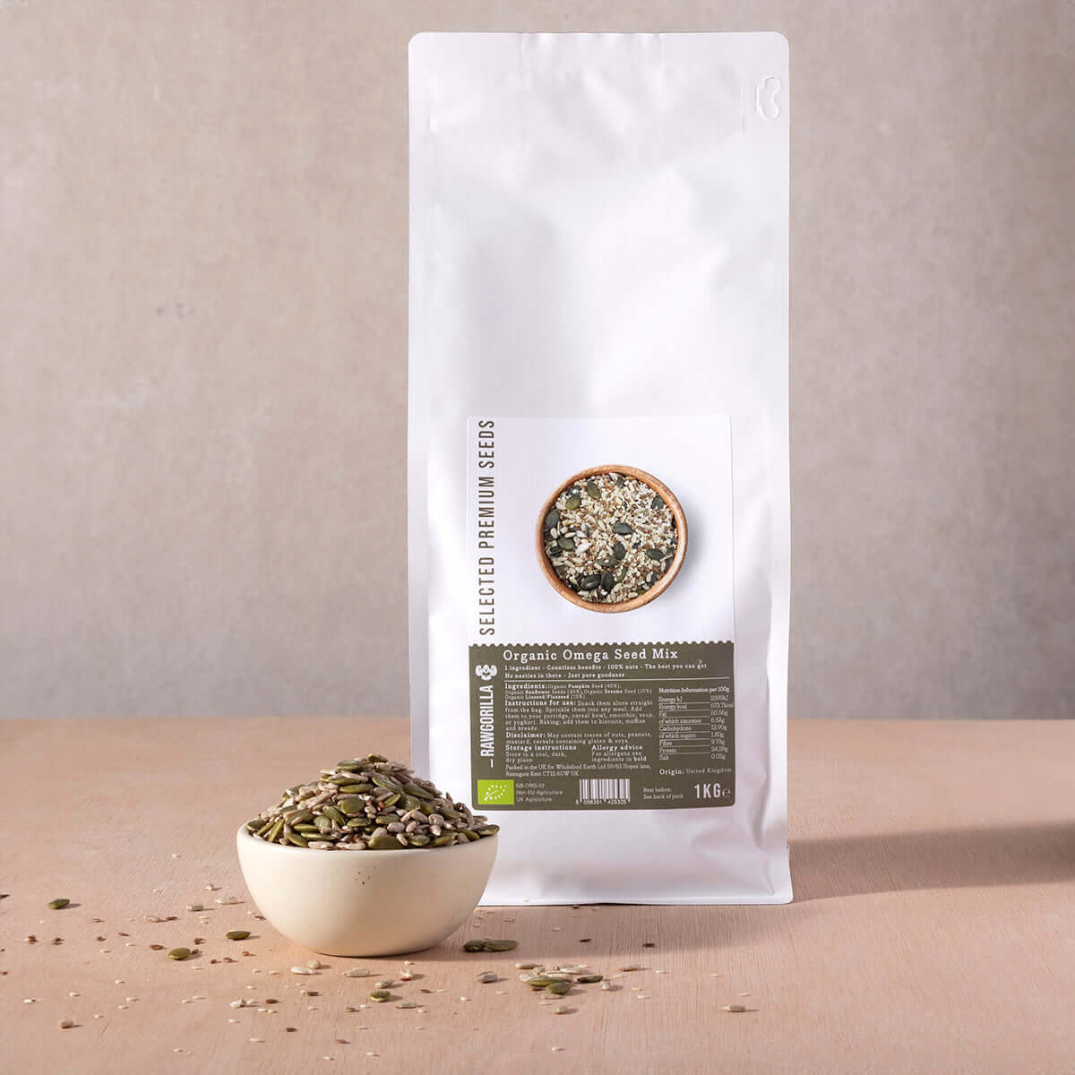 White bag of organic sunflower seed mix with a bowl of seeds on a beige background