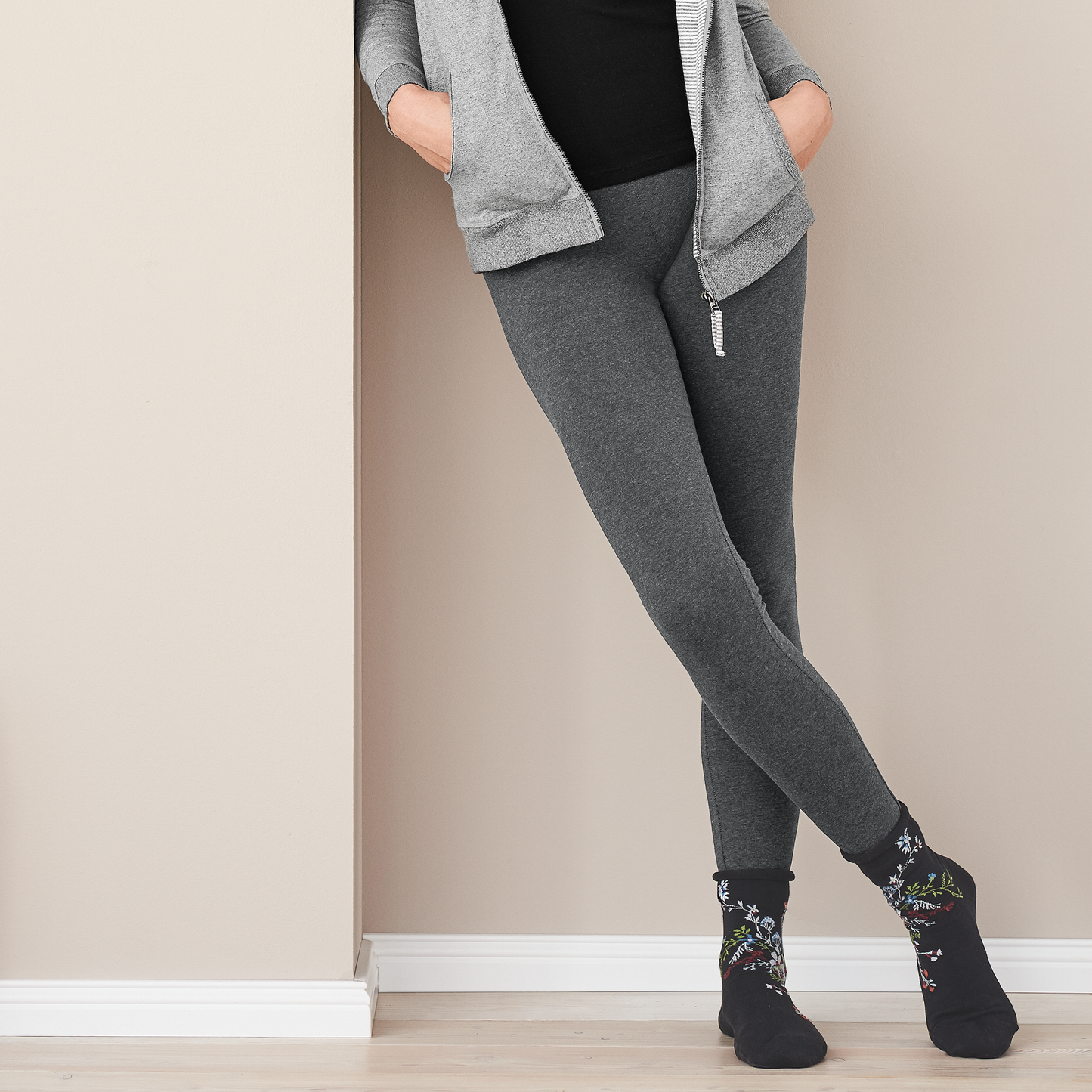 Organic Stretch Fleece Leggings: Womens worn by model in a relaxed pose against a wall, showcasing the slim-fit design.