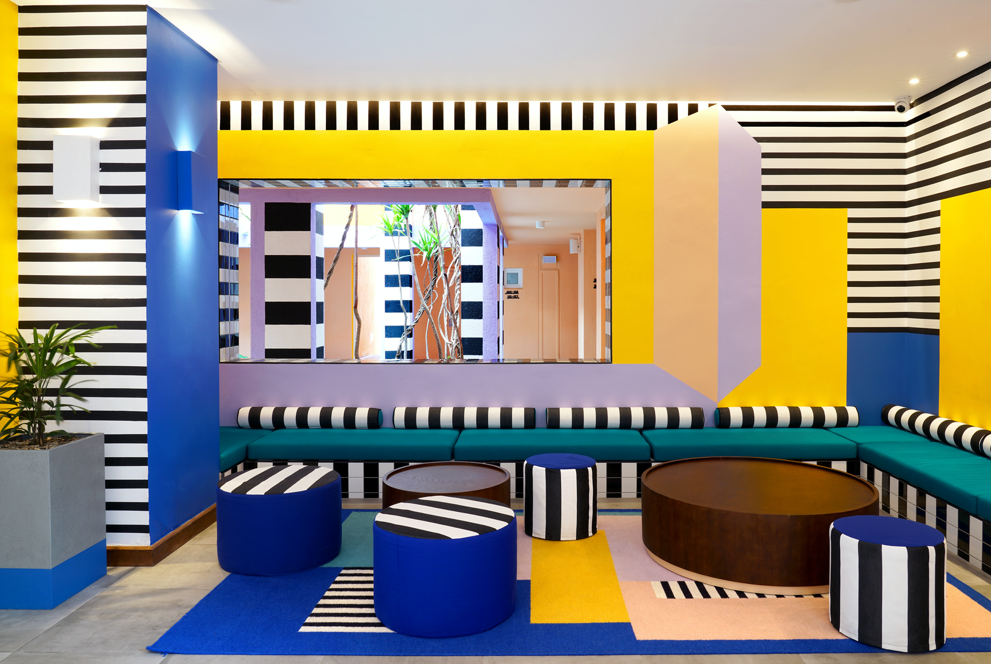 Modern interior design with colorful walls, furniture, and a TV.